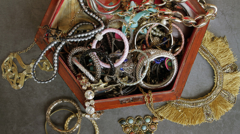 Unorganized jewelry in a wooden box