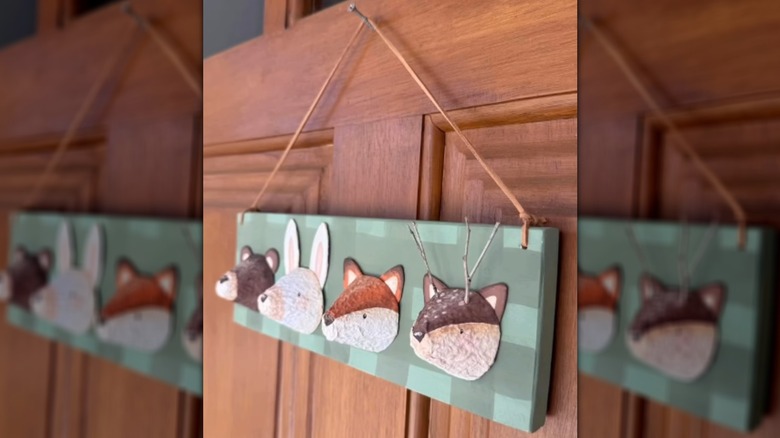 A woodland animal decor hanging against the door of a house