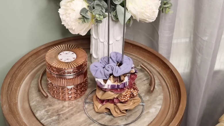 A stack of scrunchies on a paper towel holder.