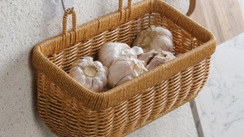Hanging wall basket in a kitchen holding heads of garlic