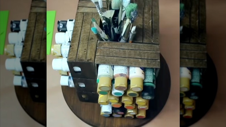 A rotating arts and crafts pegboard organizer built from Dollar Tree products.