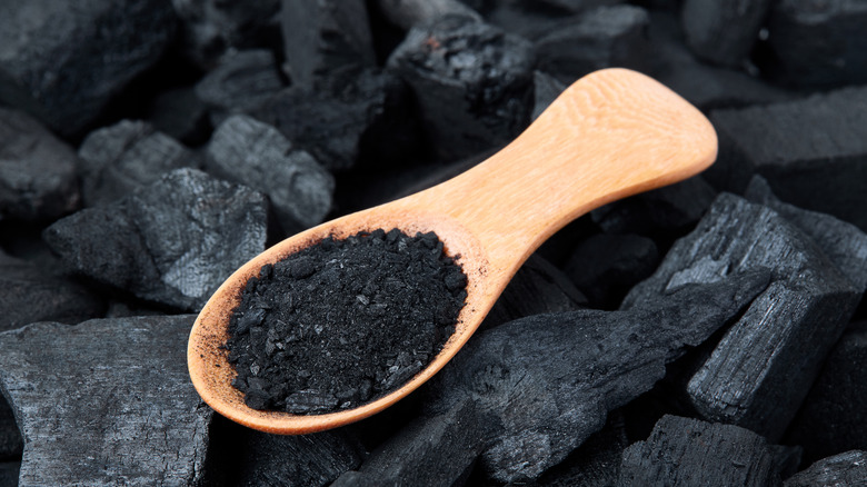 activated charcoal in a wooden spoon