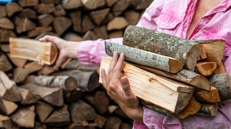 woman holding firewood