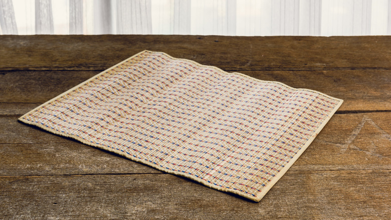 A placemat on a wood floor