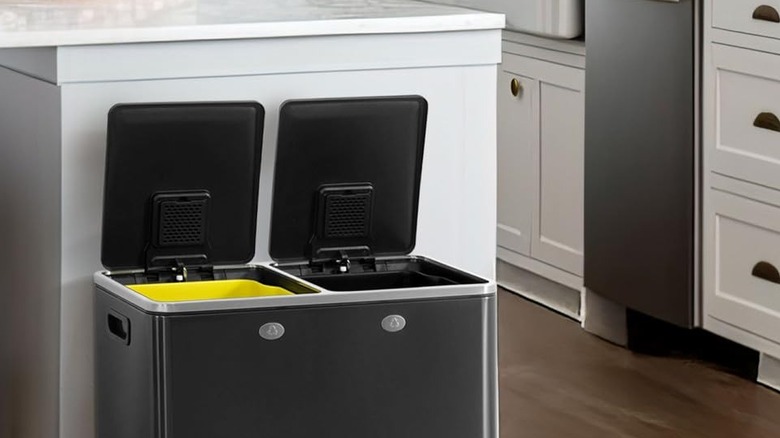 Close-up of a black dual trash can in a kitchen