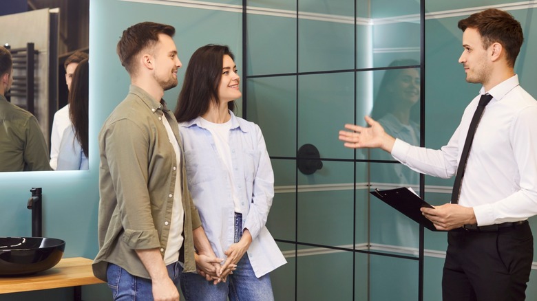 A couple contemplating options in a showroom