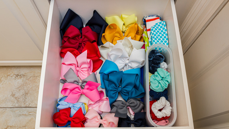 A drawer full of hair bows, headbands, and scrunchies