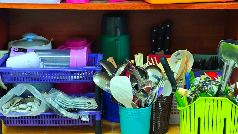 cluttered kitchen cabinet