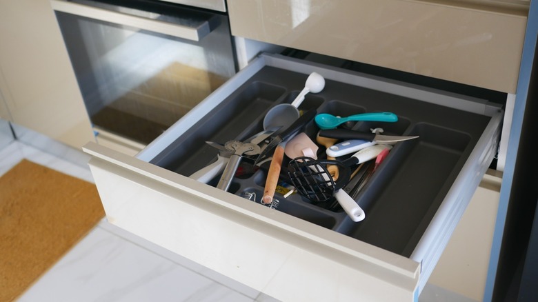 Kitchen drawer cluttered with utensils