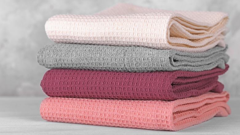 A stack of neatly folded kitchen tea towels.