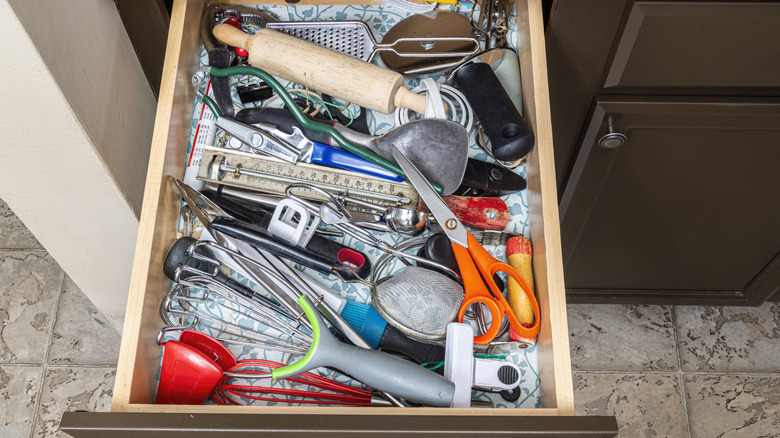 A cluttered kitchen drawer