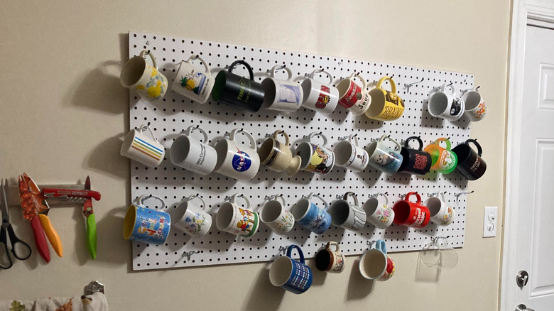 screenshot of mugs hanging on a white pegboard
