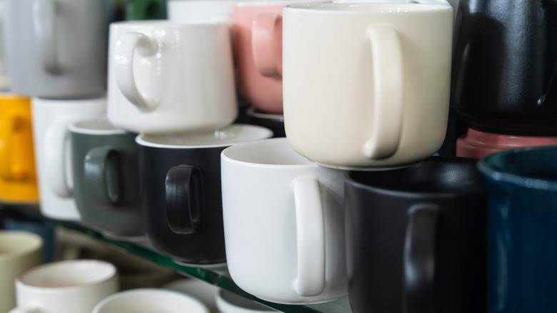 close up of various mugs stored on a shelf