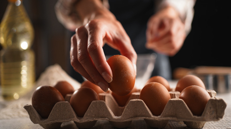 Empty cardboard egg carton sitting on a plain surface