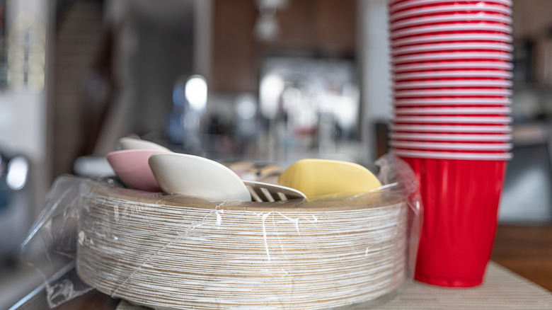 pile of paper plates and red solo cups