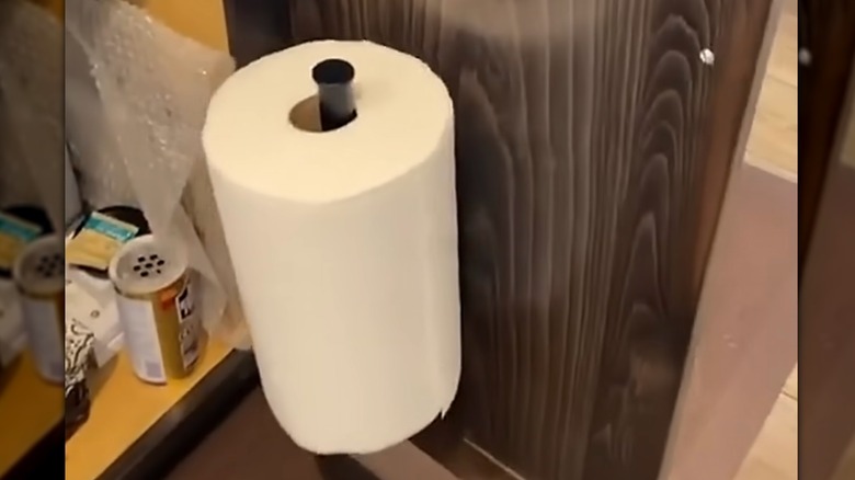 toll of paper towel inside a cabinet
