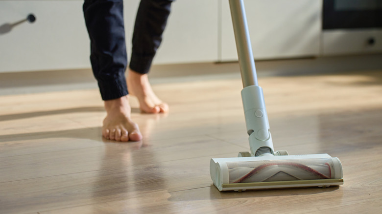 person vacuuming floor