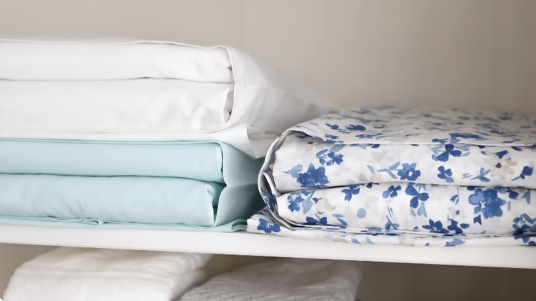 Folded sheets stored inside a pillowcase.
