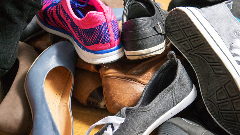 shoes of various types and colors in a pile