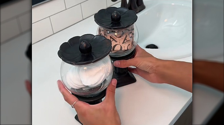 Two stylish storage containers made from candle holders and glass bowls