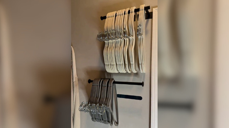 Hangers neatly lined on a paper towel rod