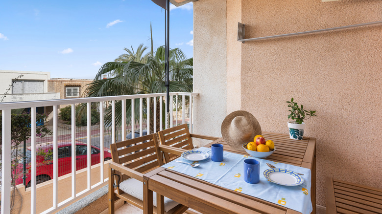 A balcony table set for dining