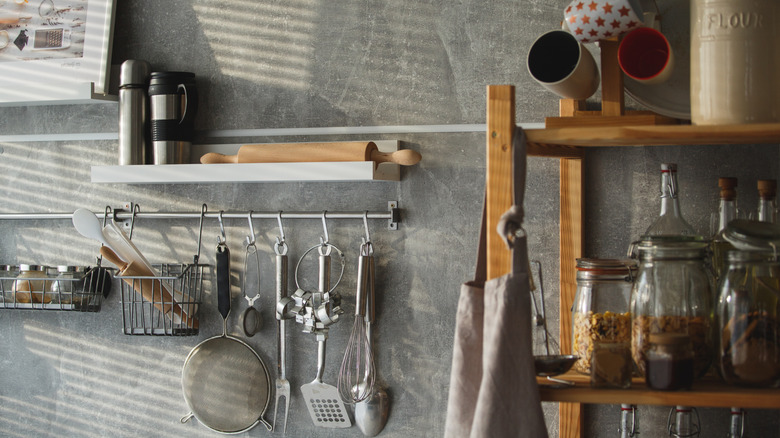 Kitchen essentials hanging on the wall.