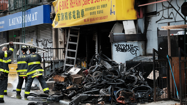 Fire-damaged e-bikes outside a repair shop
