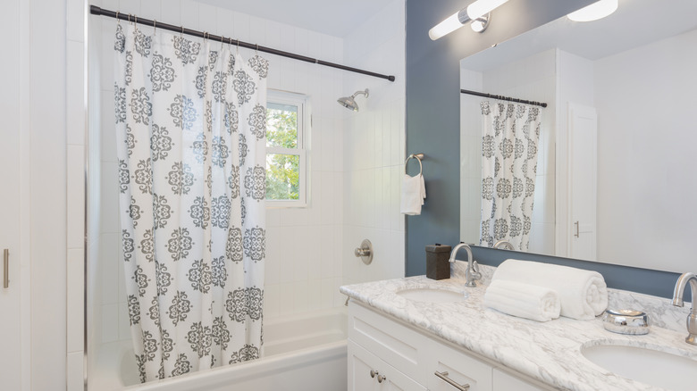 Shower curtain in white bathroom