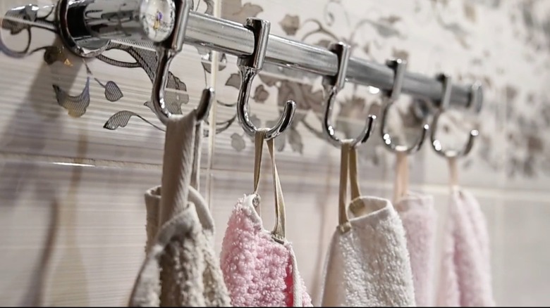 Bath towels hanging from DIY ribbon loops that have been sewn on.