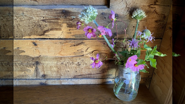 Newspaper helps hold flowers in place in a vase