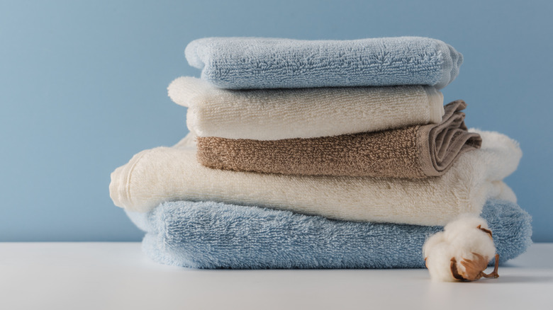 blue white and brown towels folded and sitting on counter