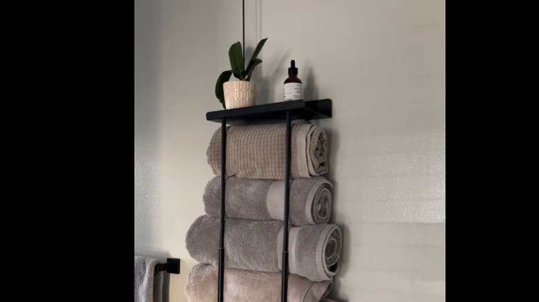 Large towels stored in wall-mounted rack