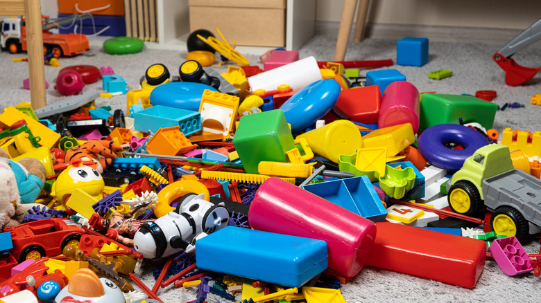 Colorful toys in a messy pile on the floor