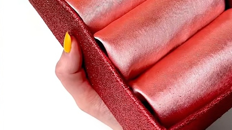 A jewelry and watch organizer made from toilet paper rolls.