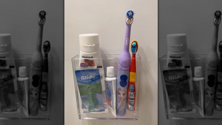 Toothbrush caddy mounted on the wall in a bathroom