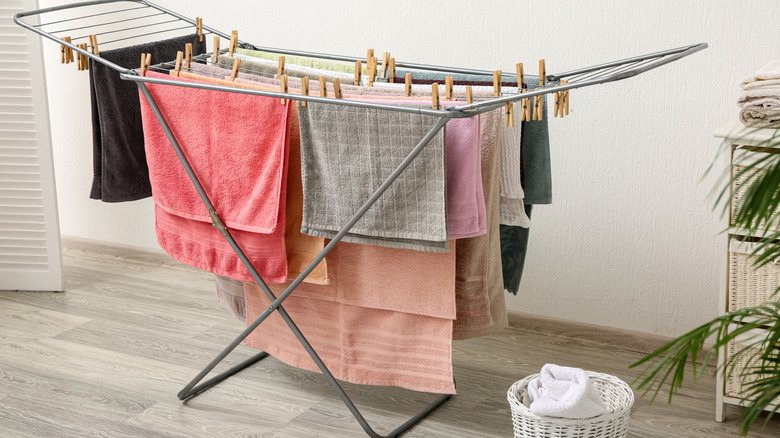 Towels hanging on a drying rack outside the bathroom.