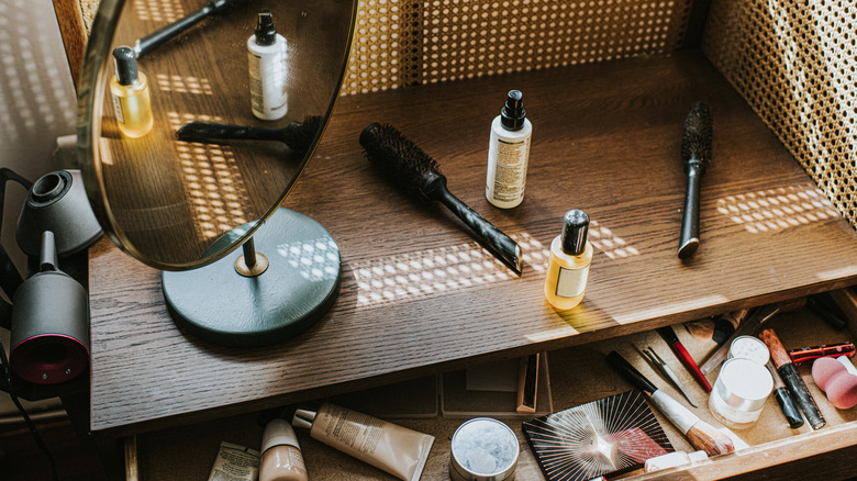 A messy makeup drawer and top