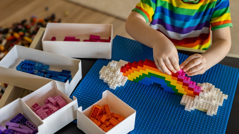 child playing with lego bricks