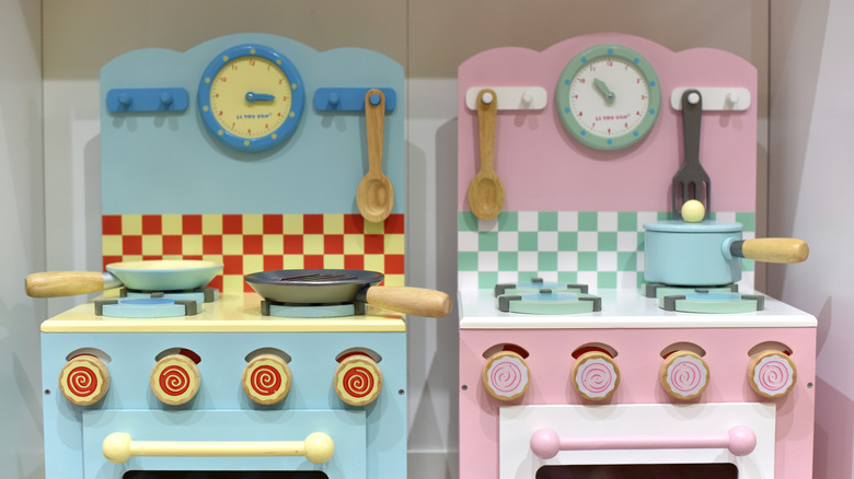 Two toy kitchen sets side-by-side
