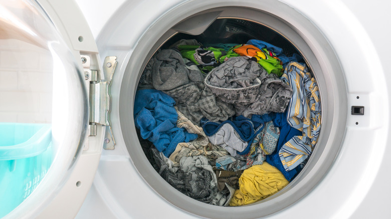 Door open of a front-load washer filled with wet clothes