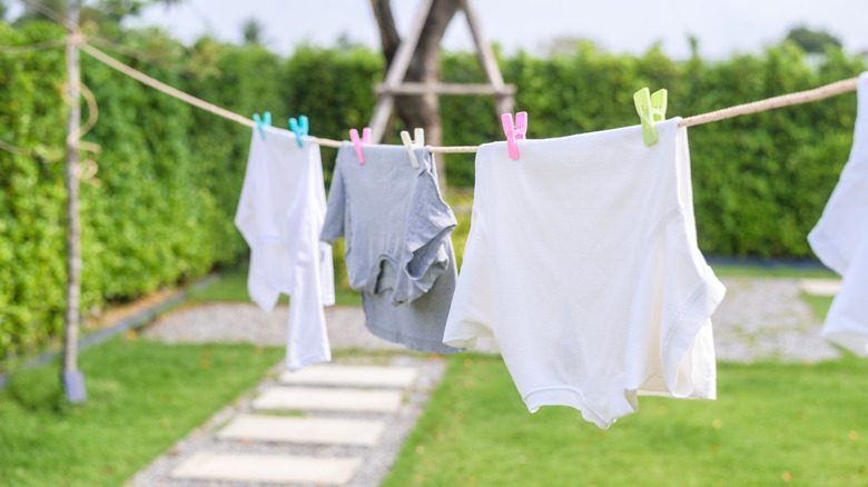 Laundry hanging on a clothesline in the yard