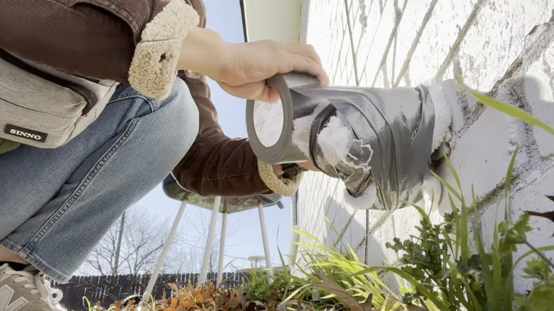 Outdoor faucet wrapped in a towel and duct tape