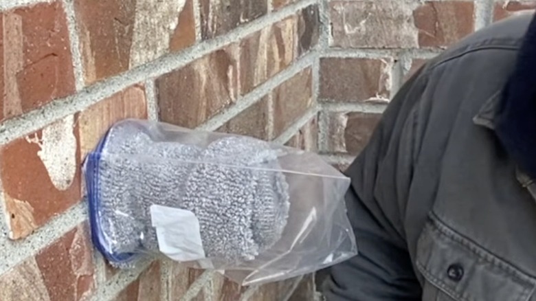 DIY faucet cover with sock and plastic bag