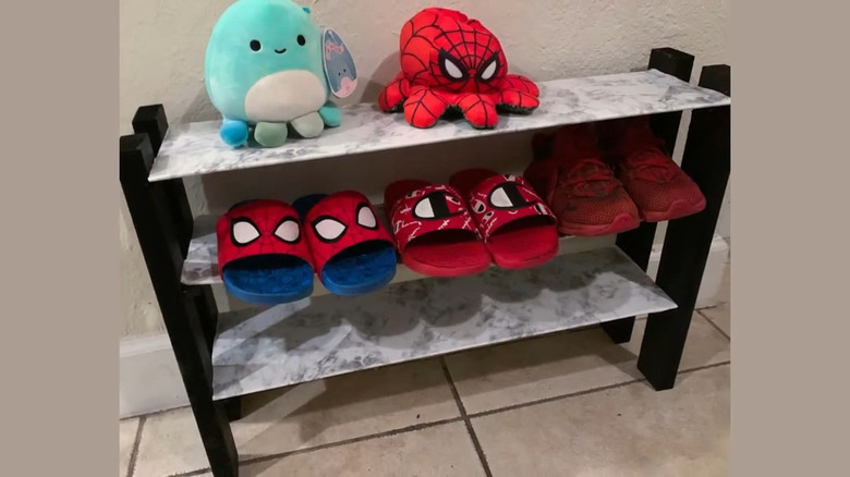 A children's shoe rack with spider man toys