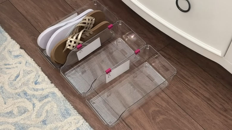 Clear plastic bins attached with binder clips