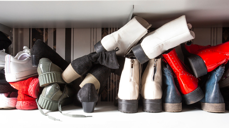 shoes piled messily in closet