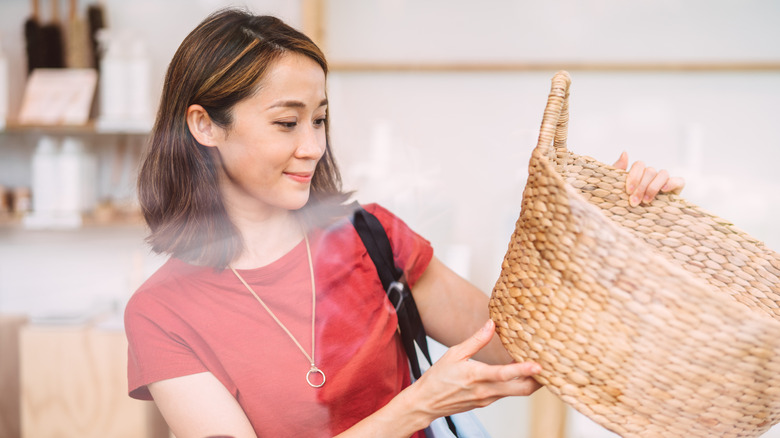 Woman shopping for a wicker basket
