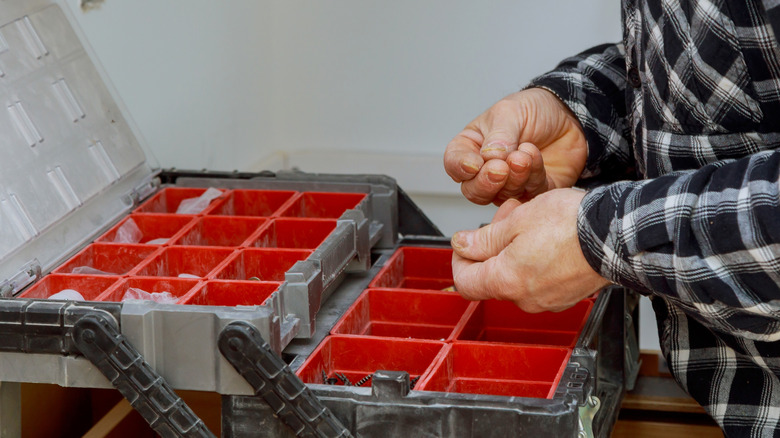 Man organizes toolbox