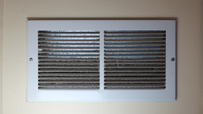 Closeup of an air vent grill with built-up dust